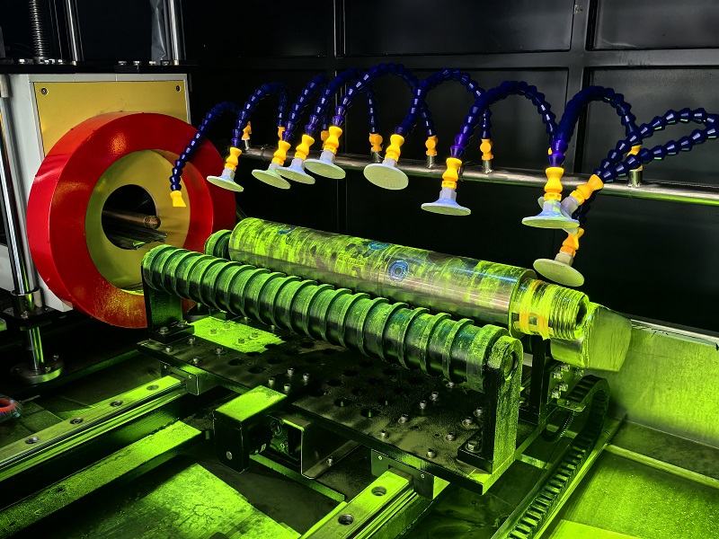 Fluorescent magnetic particle inspection of valve stem under UV light in darkroom